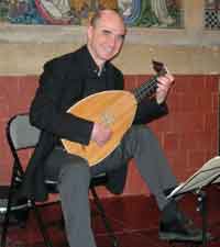 Raymond Coust&eacute; playing lute at the Grove Garden Chapel