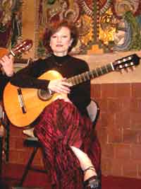 Vincea McCelland playing guitar at the Grove Garden Chapel